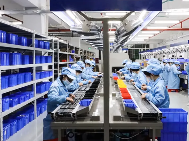 YenGear electronics assembly line with workers inspecting circuit boards