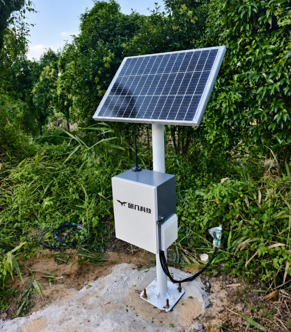 Solar panels and a cabinet supplying an outdoor site